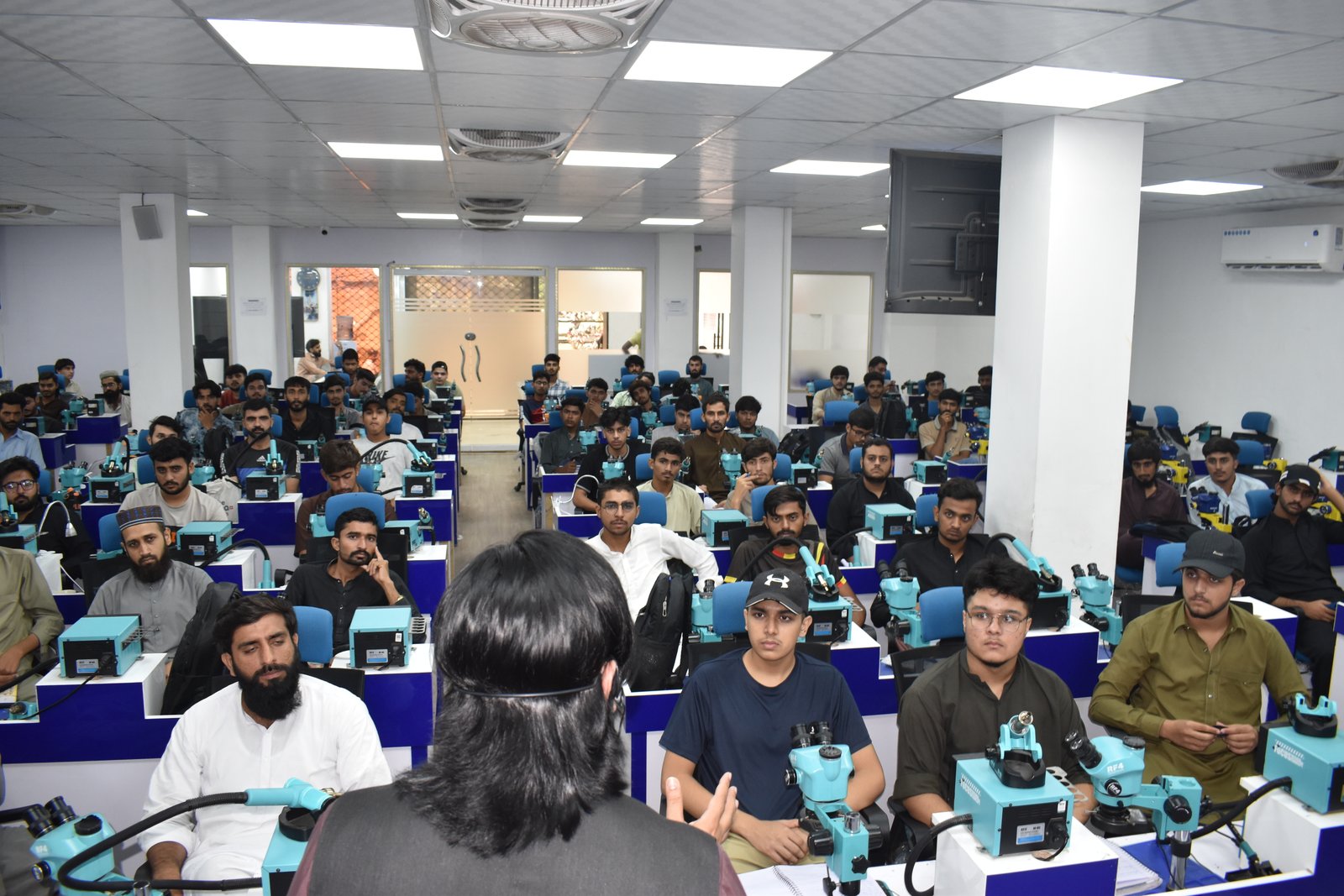 Training benches and equipment inside Punjab Mobile Repairing and Training Center, Lahore
